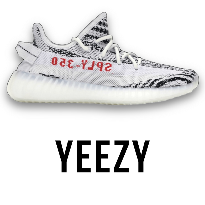 Yeezy Boost 350 V2 'Zebra' sneakers featuring a white and black striped Primeknit upper with red 'SPLY-350' text, available at Jawns on Fire Sneaker Boutique